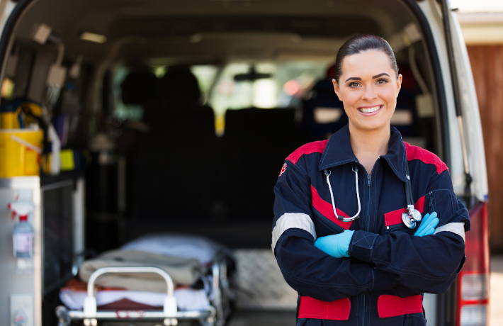 Mulher Jovem trabalhadora do serviço médico de emergência na frente de ambulância.